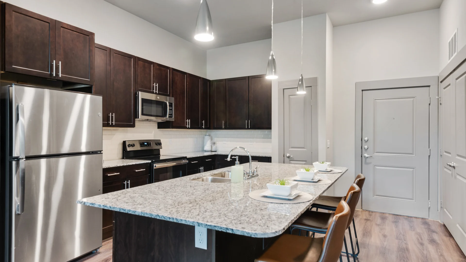 a kitchen with stainless steel appliances and granite counter tops at The Discovery Park