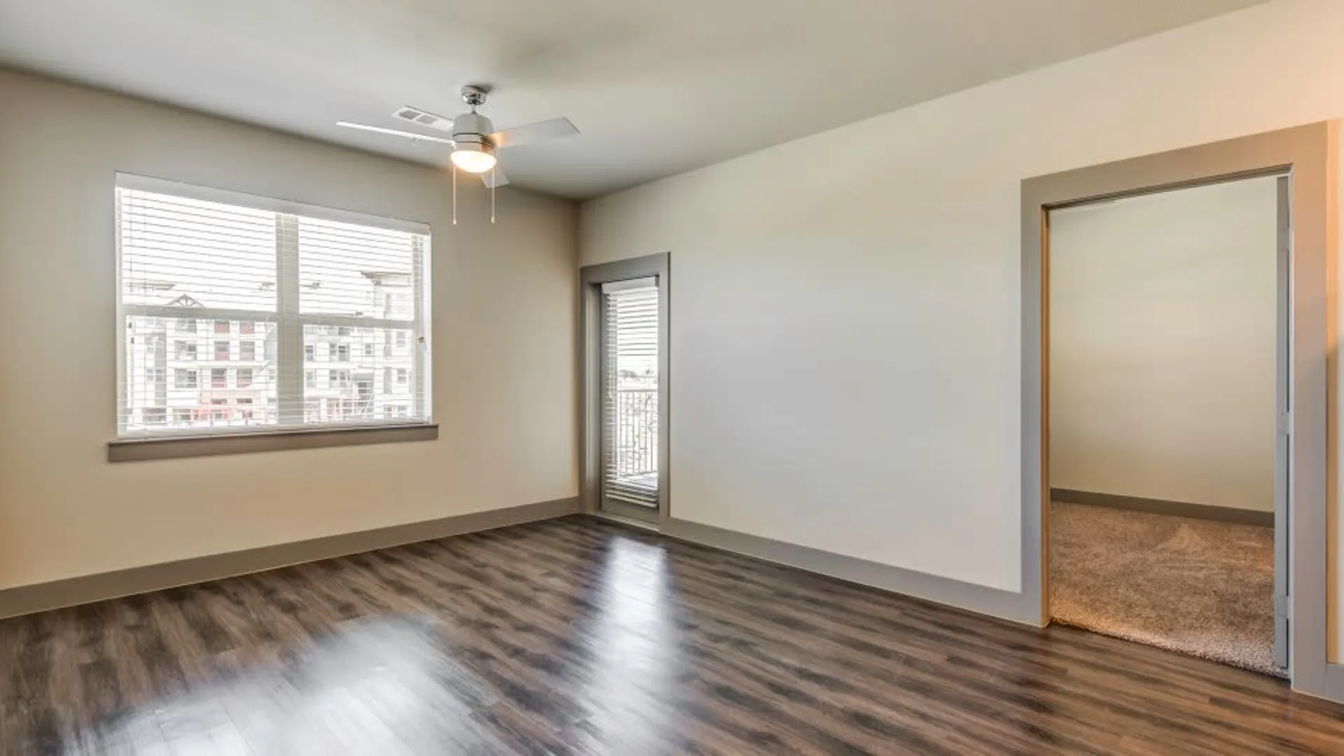 empty room with hardwood floors and ceiling fan at The Discovery Park